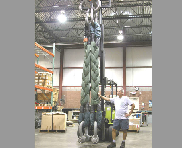 A man standing next to a heavy-duty lifting device