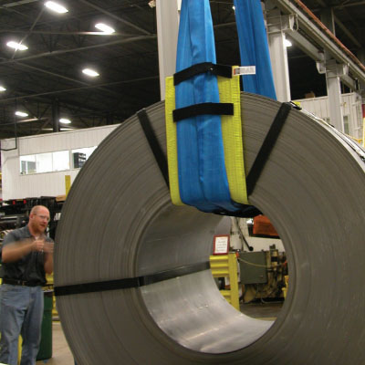 a large load held up by a sling with sling protection equipment and wear pads